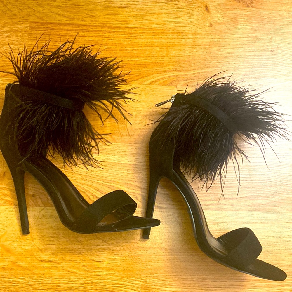 Gently worn open toe heels with feather around ankle.